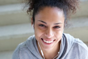 African american sports woman smiling with earphones